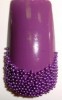 Uñas decoradas con Caviar en Morado